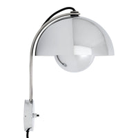 Polished chrome arc lamp with a sleek half-sphere white shade, featuring a minimalist design and modern aesthetic.