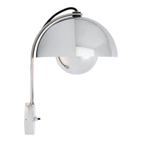 "Chrome arc lamp with a sleek metallic finish and round glass shade, perfect for modern decor."