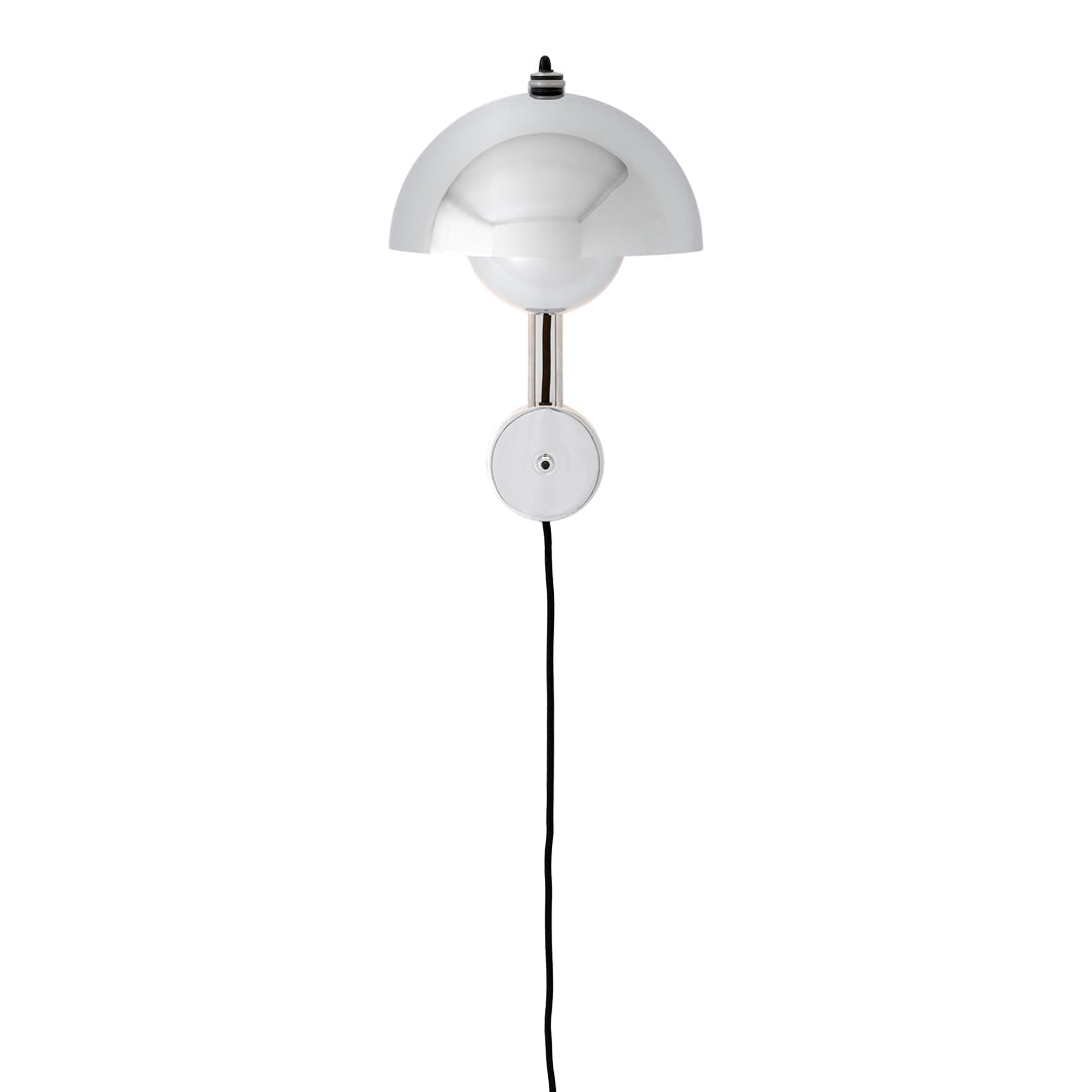 White wall lamp with rounded geometric design and sleek black cord. Minimalist silhouette adds modern elegance.