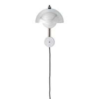 White wall lamp with rounded geometric design and sleek black cord. Minimalist silhouette adds modern elegance.