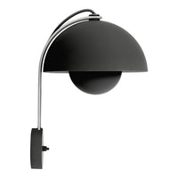 Sleek black lamp with smooth curves and a glossy finish, featuring a minimalist design and chrome accents.