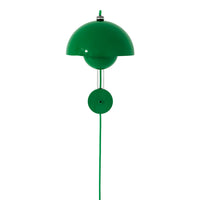 Bright green dome lamp with a sleek design and smooth finish, featuring a contrasting round base.