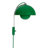 Green dome-shaped wall lamp with a chrome arm and cord, featuring a sleek, modern design.