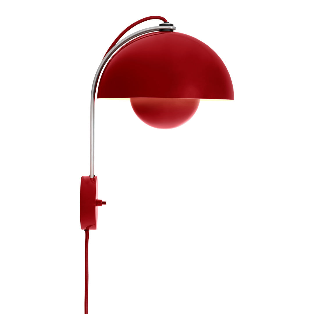 Red wall lamp with a glossy dome shade and chrome accents, featuring a round light globe and a matching red cord.