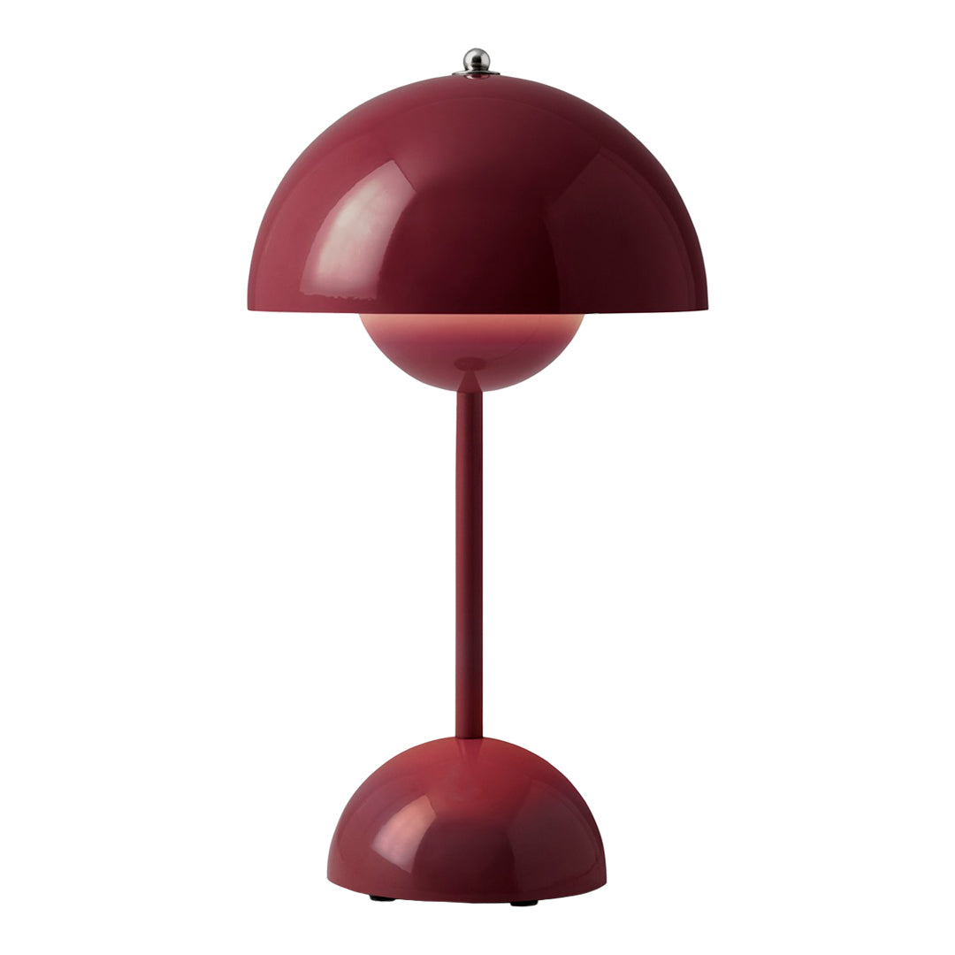Red dome-shaped lamp with a smooth finish, featuring a matching round base and sleek, modern design.