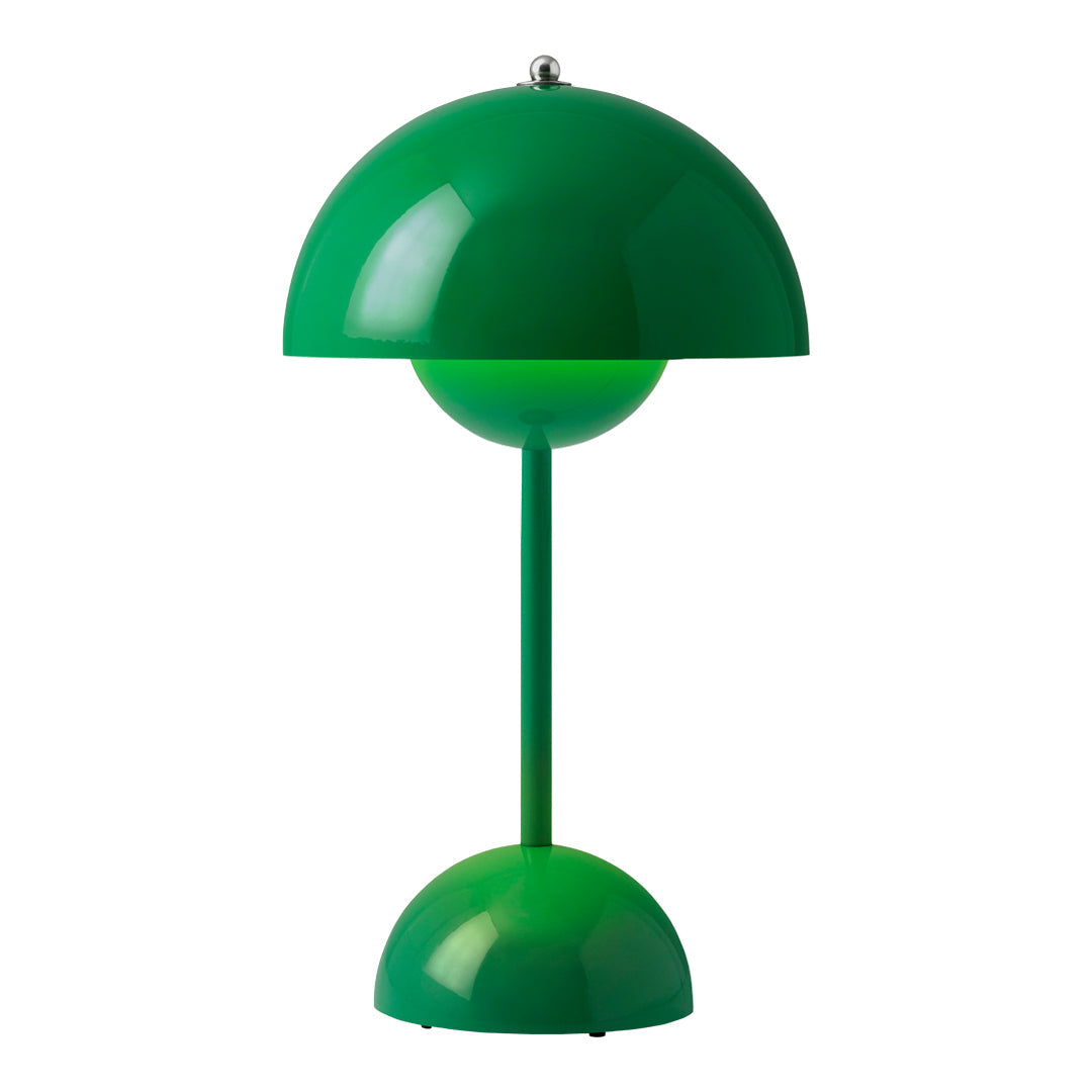 Green dome-shaped table lamp with a glossy finish and round base, featuring a playful modern design.