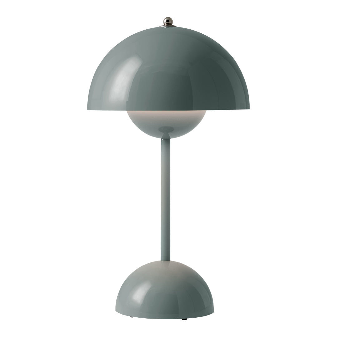 Modern table lamp in soft green with a rounded shade and base, featuring a minimalist design and smooth surfaces.