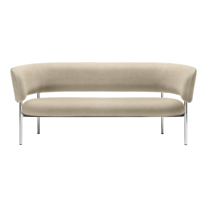 Beige curved sofa with smooth upholstery and minimalist chrome legs, perfect for modern interiors.