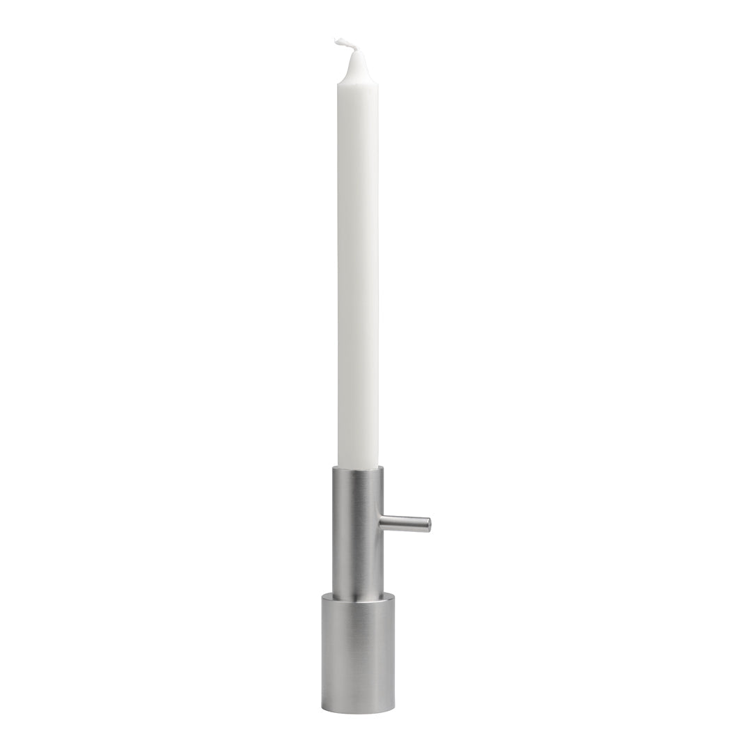 Sleek silver candle holder with a tall white candle, creating a modern, minimalist aesthetic.