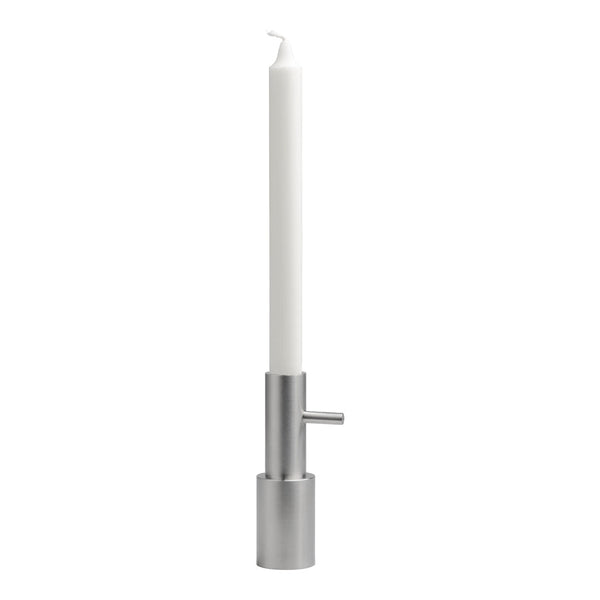 Sleek silver candle holder with a tall white candle, creating a modern, minimalist aesthetic.