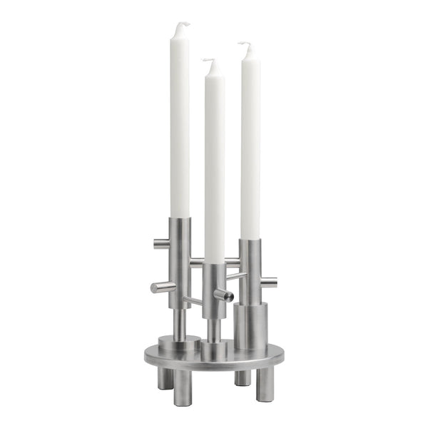 Silver metal candle holder featuring three smooth white candles for a modern, minimalist aesthetic.