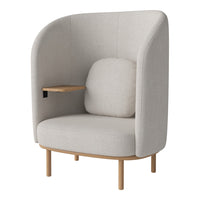 Light gray upholstered chair with a smooth, minimalist design and wooden accents, featuring a cozy side table.