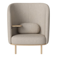 Beige upholstered chair with a curved back, wooden legs, and a side table. Simple, modern design with a cozy feel.
