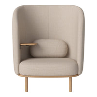 Beige upholstered chair with a smooth texture, tapered wooden legs, and a cozy circular cushion.