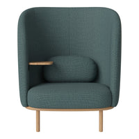Teal upholstered chair with a textured pattern and natural wood legs, featuring a rounded backrest and side table.