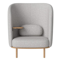 Light gray upholstered chair with a minimalist design, featuring smooth contours and a natural wood base.
