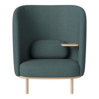 Teal upholstered armchair with a textured fabric and light wood legs, featuring a round cushion and side table.