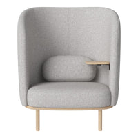 Light gray upholstered chair with a minimalist design and natural wood legs, featuring a curved backrest and side table.