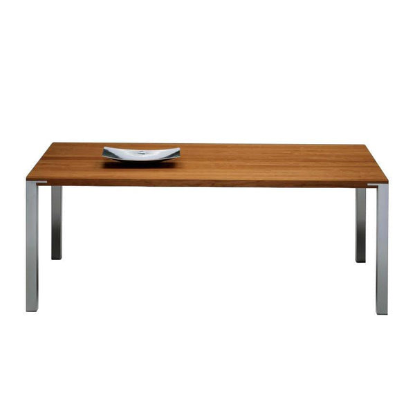 Stylish wooden table with a rich brown finish and sleek silver legs, featuring a simple round plate on top.