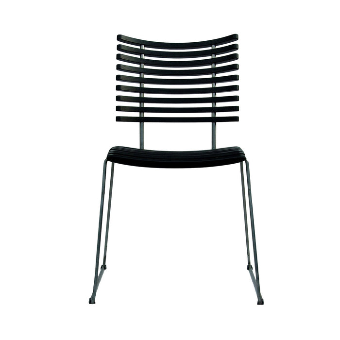 Black striped dining chair with sleek silver legs, showcasing a modern and minimalist design.