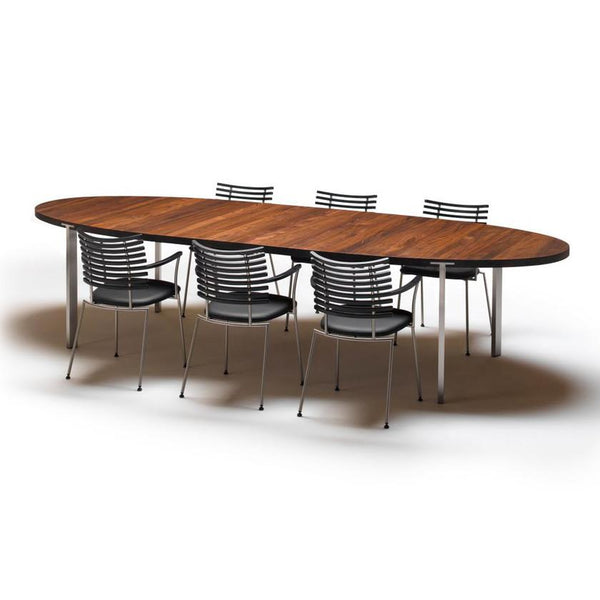 Oval wooden table with a rich brown finish, paired with sleek silver metal chairs featuring black stripes.