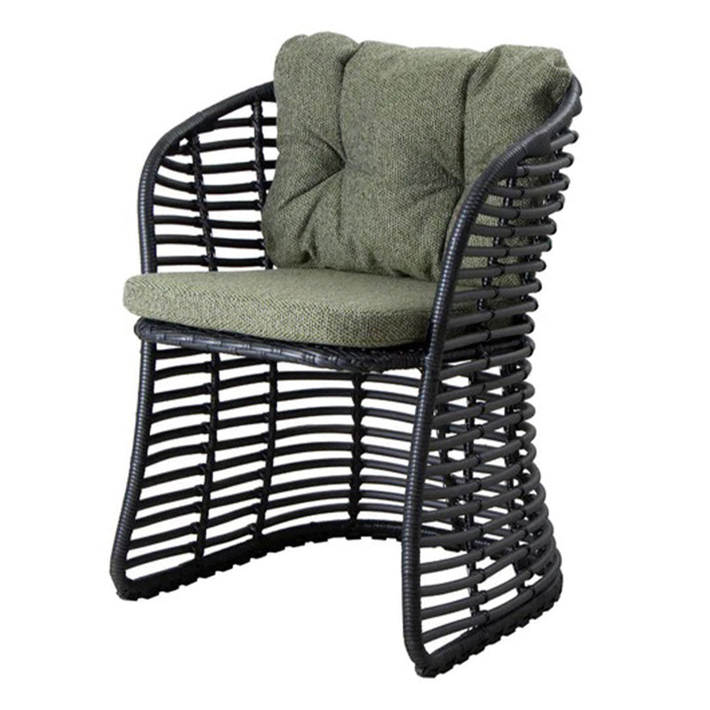 Green tufted cushion on a black woven chair showcasing a modern pattern and sleek design. Ideal for outdoor lounging.