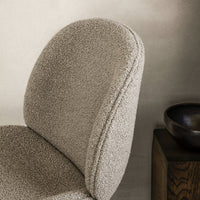 "Soft beige chair with a textured, cozy finish, perfect for modern interiors."