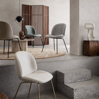 Elegant chairs in neutral tones of beige and gray, with textured fabrics and sleek metal legs, set against a modern backdrop.