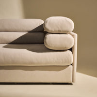 Beige sofa with soft, rounded cushions and a smooth, modern design against a neutral background.