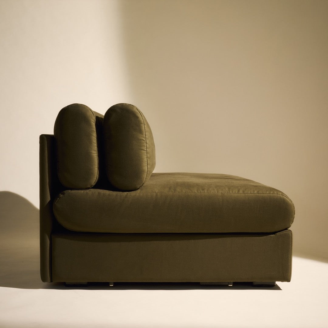 Olive green chaise lounge with a smooth fabric texture and rounded cushions, minimalist design for modern decor.
