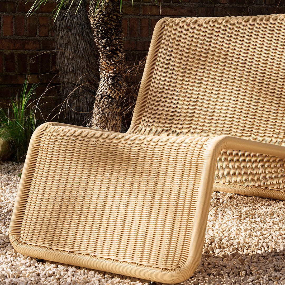 Beige striped lounge chair with a modern, textured pattern, perfect for outdoor relaxation.