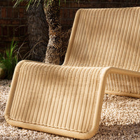 Beige striped lounge chair with a modern, textured pattern, perfect for outdoor relaxation.