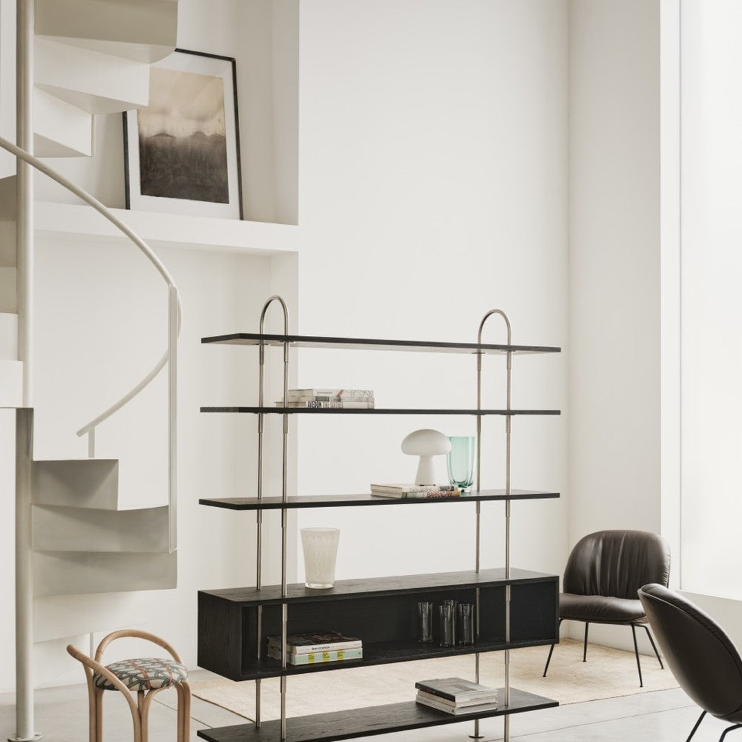 Modern black metal shelving unit with sleek lines and glass accents, set against a neutral, minimalist background.