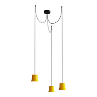 "Modern pendant light with three yellow shades and sleek black ceiling mount, showcasing a minimalist design."