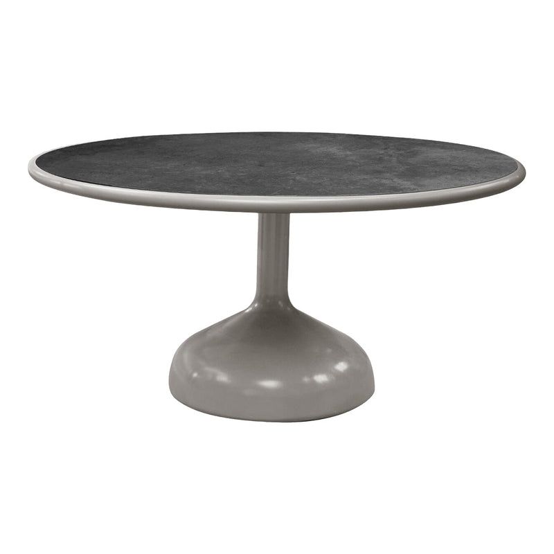 Round table featuring a sleek grey base and a dark patterned tabletop, ideal for modern decor.