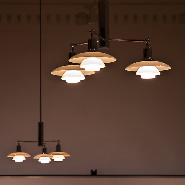 Modern pendant lights featuring a sleek black frame and white, dome-shaped shades. Elegant and contemporary design.