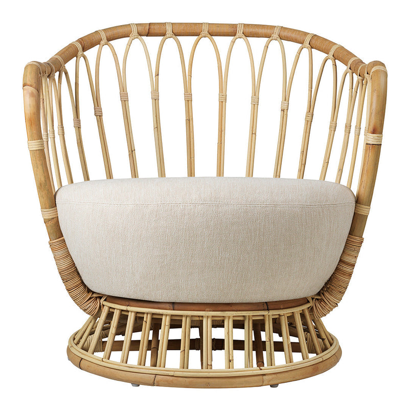 Natural rattan chair featuring a smooth beige cushion and a circular woven base for a modern aesthetic.