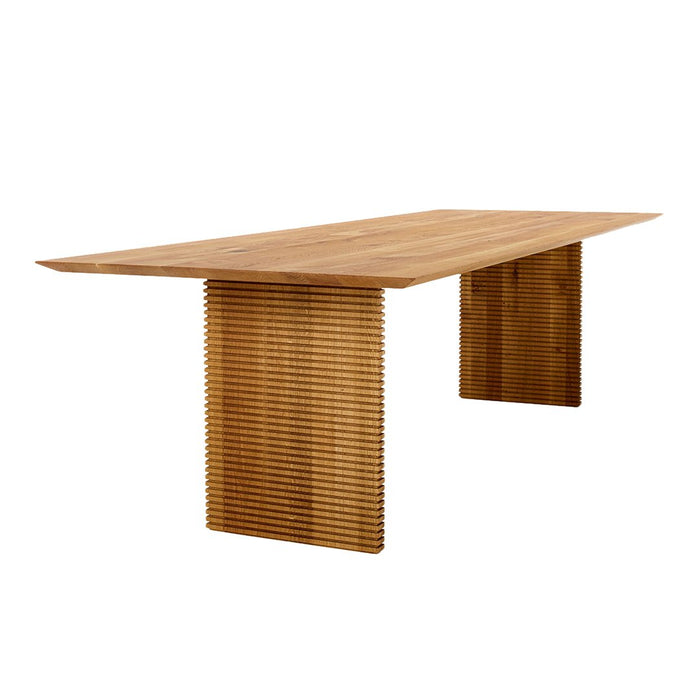 Natural wood dining table with smooth, light oak finish and textured, slatted support. Stylish and modern design.