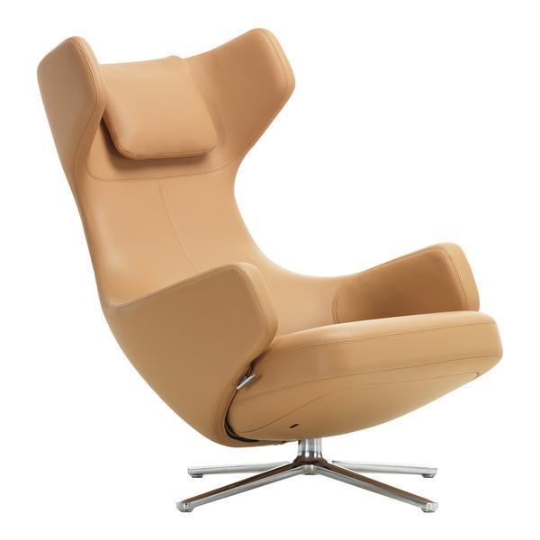 Tan leather armchair with a sleek, modern design and a polished chrome base. Perfect for stylish interiors.