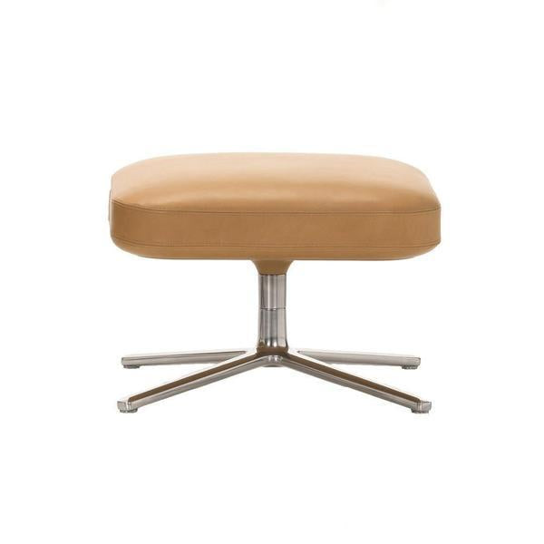 Tan leather ottoman with a sleek silver base, featuring a smooth, minimalistic design. Perfect for modern decor.