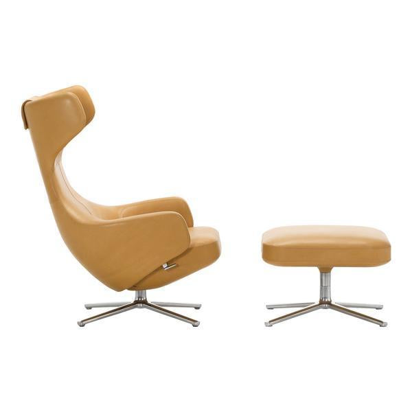 Modern beige leather chair and ottoman set with sleek chrome base, featuring smooth, minimalist design.