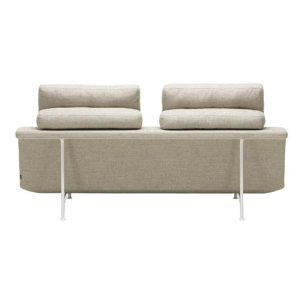 Beige sofa with two plush cushions, featuring a smooth texture and minimalist design on a sleek white base.