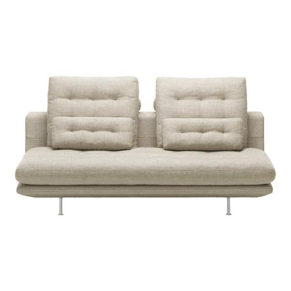 Light beige upholstered sofa with tufted back cushions and sleek metal legs. Modern, minimalist design.