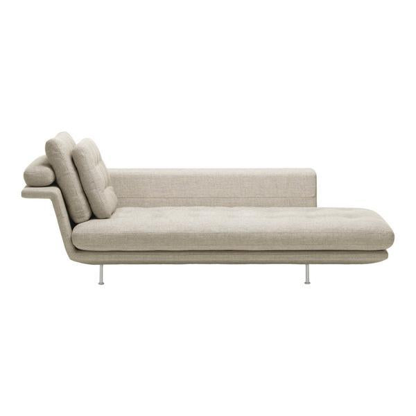 Beige fabric chaise lounge with a smooth texture and minimalist design, featuring subtle, modern lines.