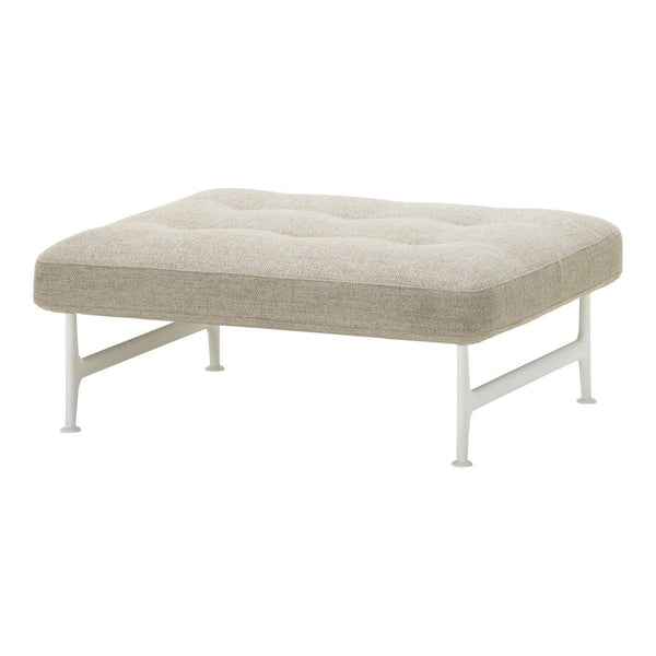 Light beige upholstered ottoman with tufted pattern and sleek white legs, perfect for modern decor.