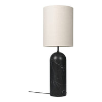 Table lamp with black marble base and white lampshade on a white background