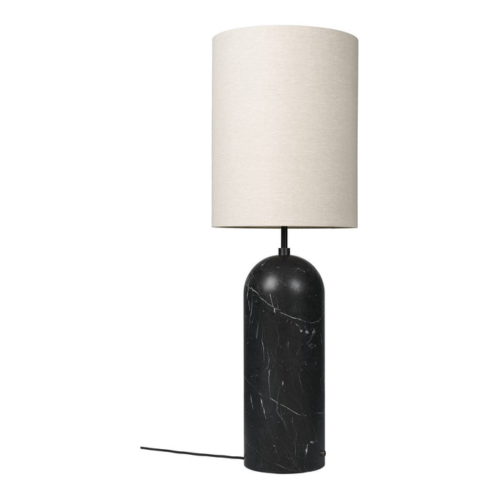 Table lamp with black marble base and white lampshade on a white background