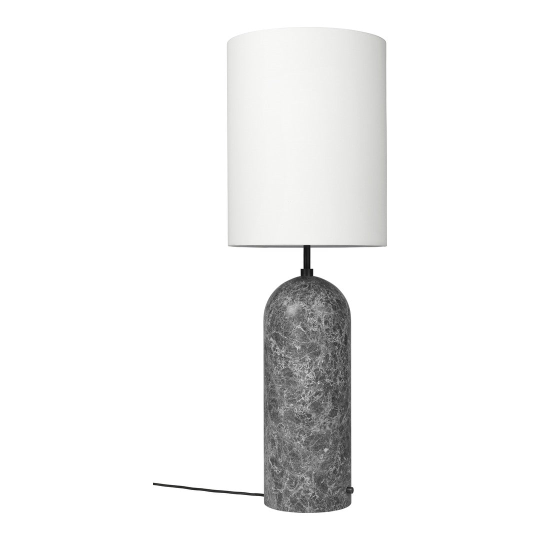 Table lamp with a gray textured base and white shade on a white background