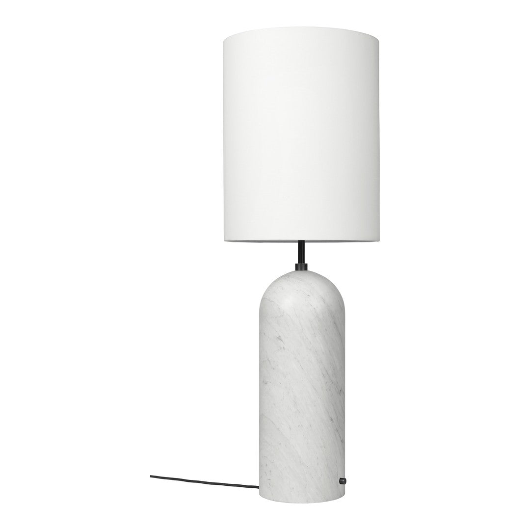 Table lamp with white marble base and white shade on a white background