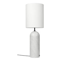 Table lamp with white marble base and white shade on a white background